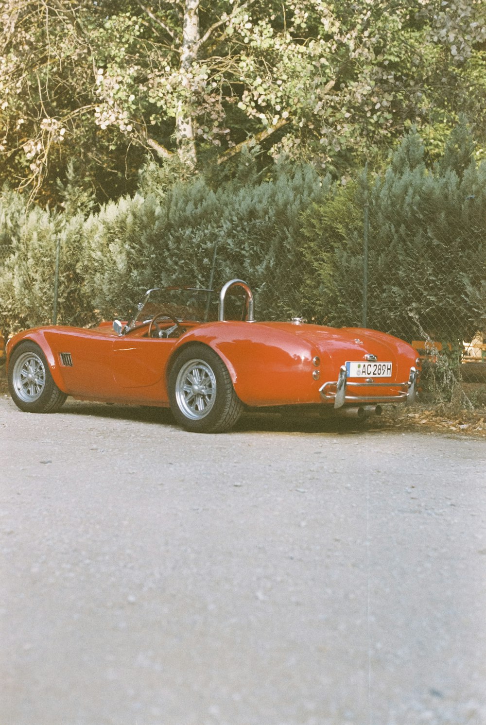 a red sports car parked on the side of the road