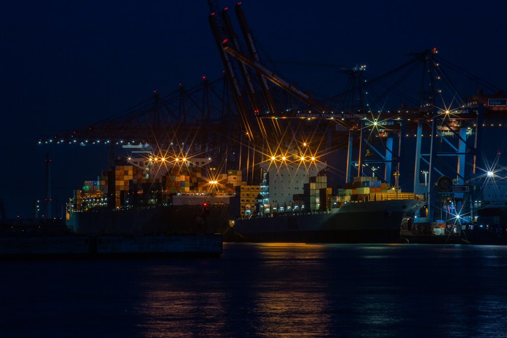 a large cargo ship in a harbor at night