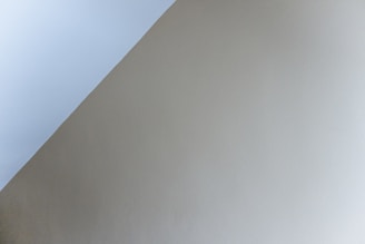 Diagonal transition between two sections with soft silver accents and parallax effect.