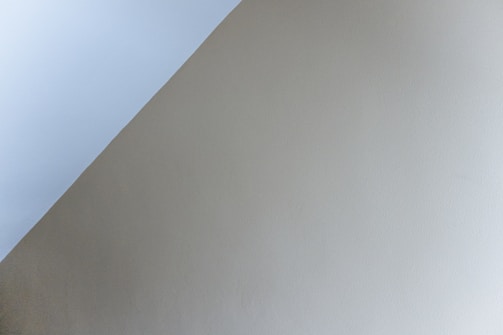 Diagonal transition between two sections with soft silver accents and parallax effect.