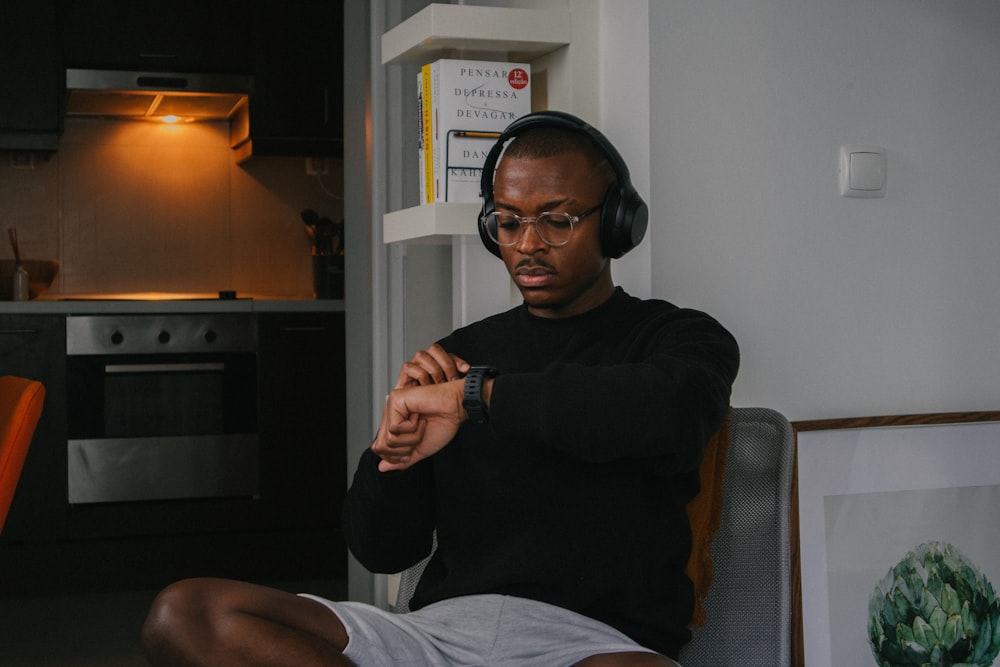 a man wearing headphones sitting in a chair