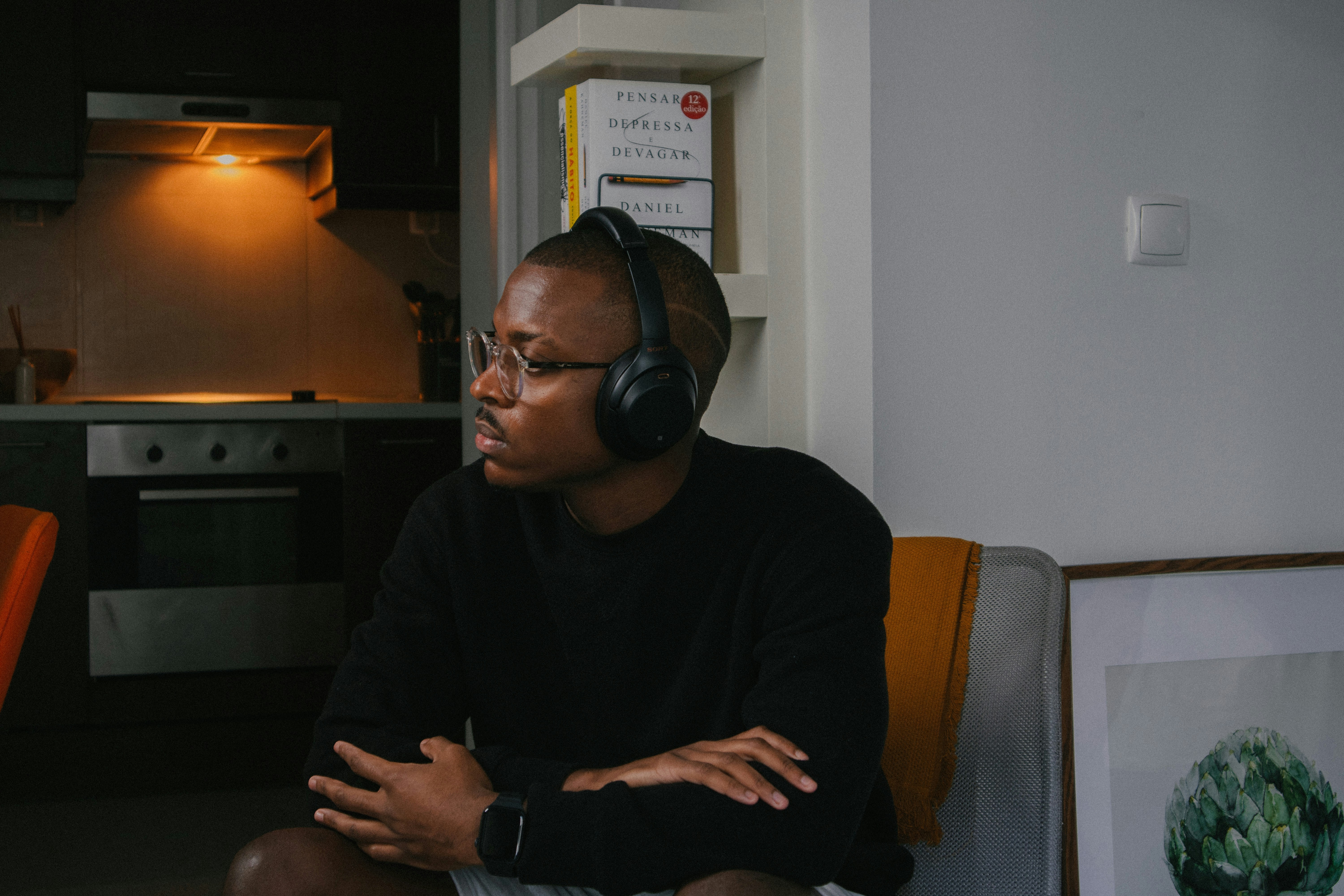 a man sitting in a chair wearing headphones