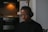 A person listening to radio with headphones in a modern home setting.