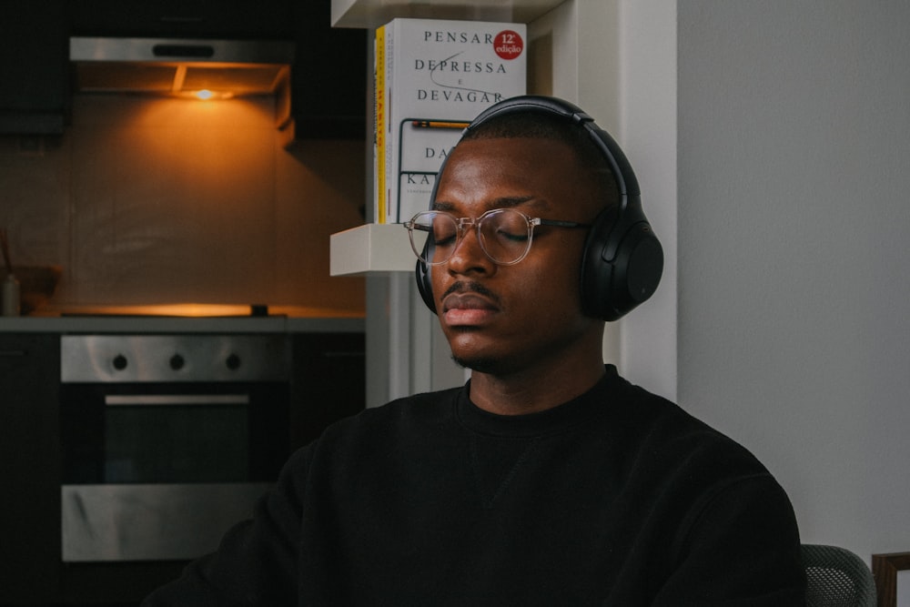 a man wearing headphones sitting in a chair