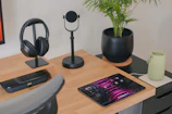 Sheet music and headphones on a wooden desk in a creative workspace