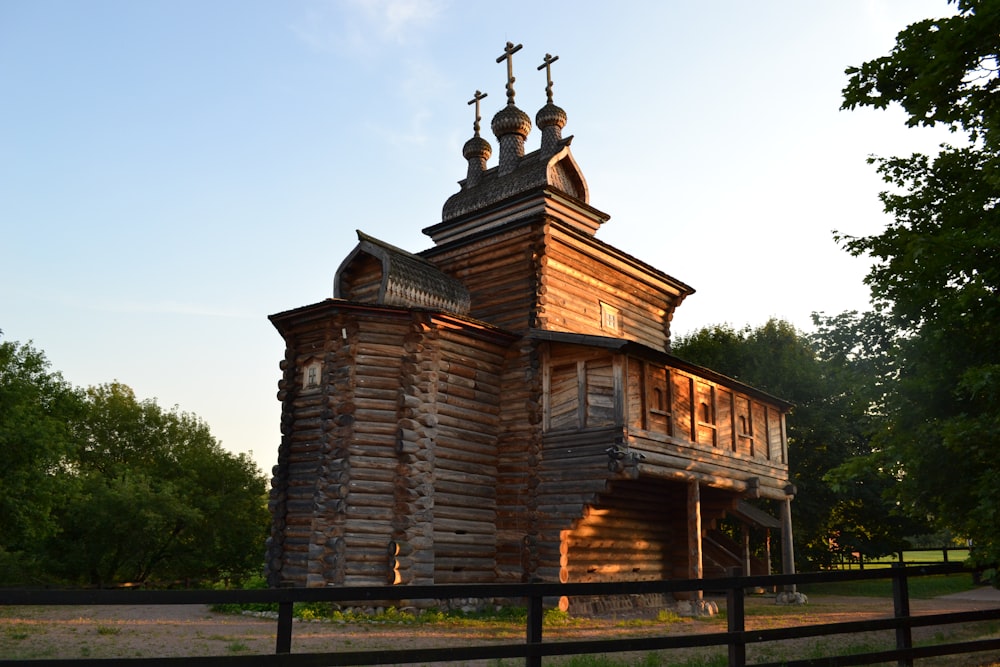 a wooden building with a cross on top of it