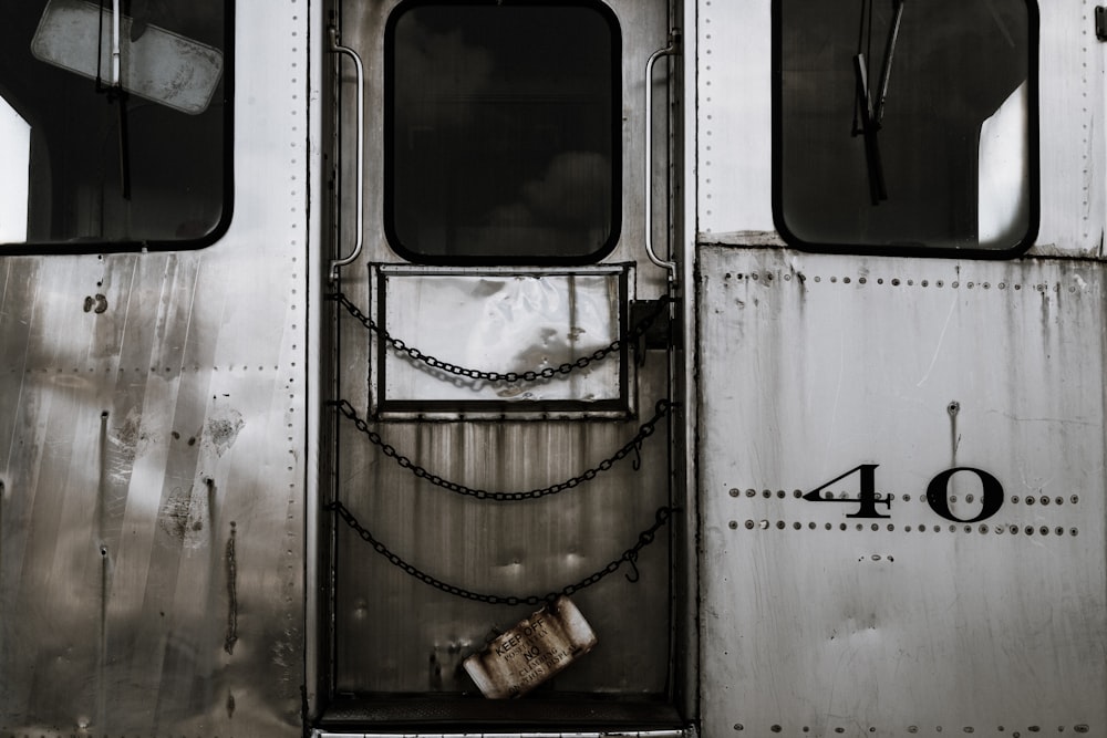 the door of a train with a chain on it