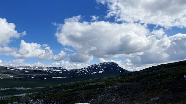 a view of a mountain range with snow on the ground