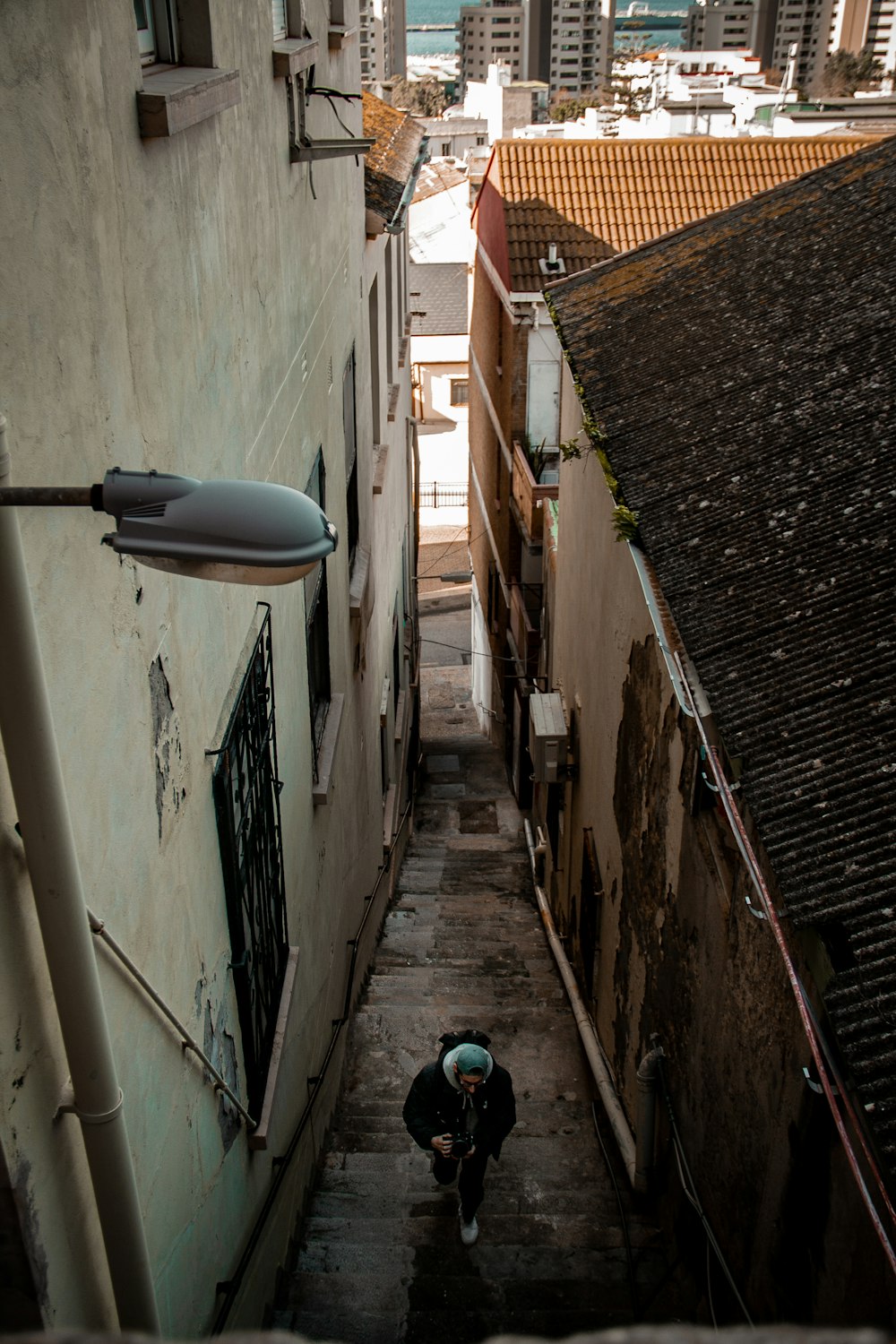 a man walking down a flight of stairs in a city