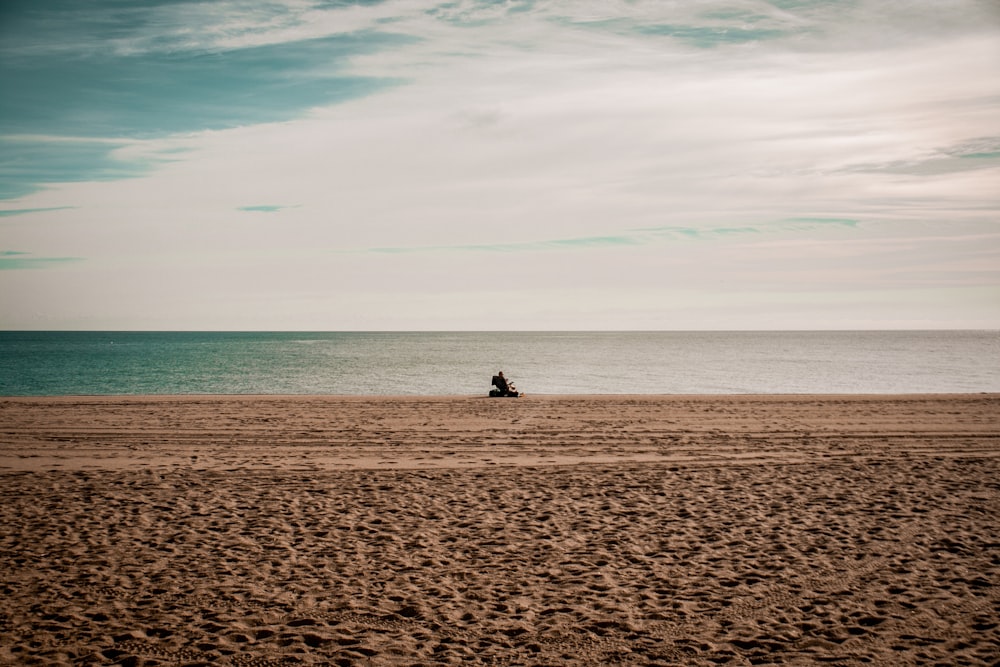 a person riding a horse on a beach