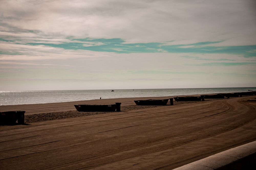 a sandy beach with a few boats on it