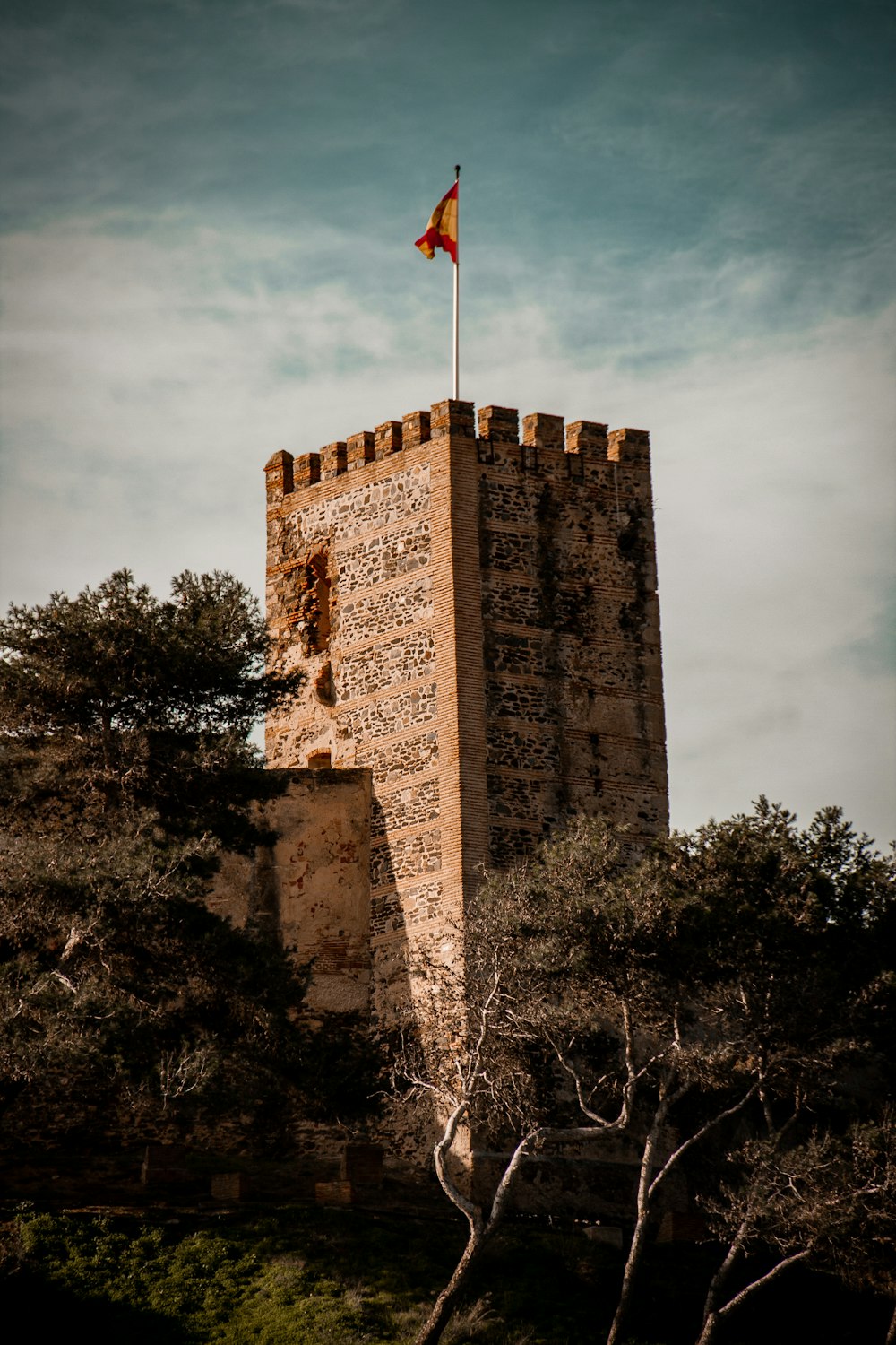 a tall tower with a flag on top of it