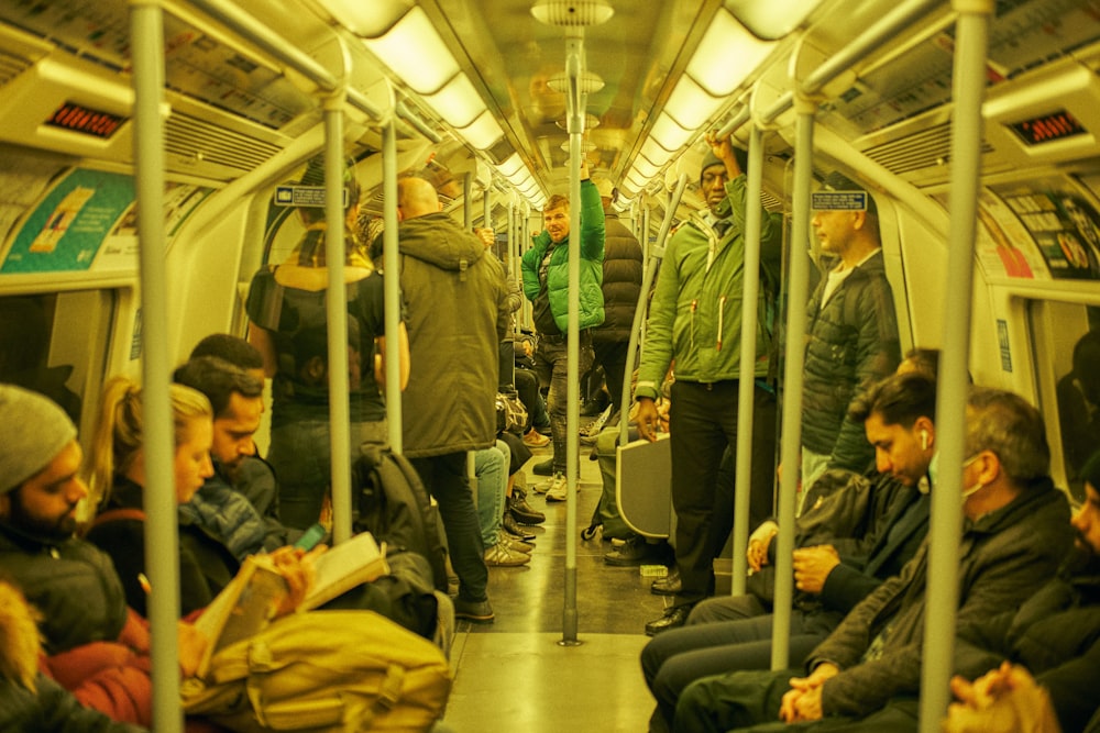 a group of people riding on a subway train