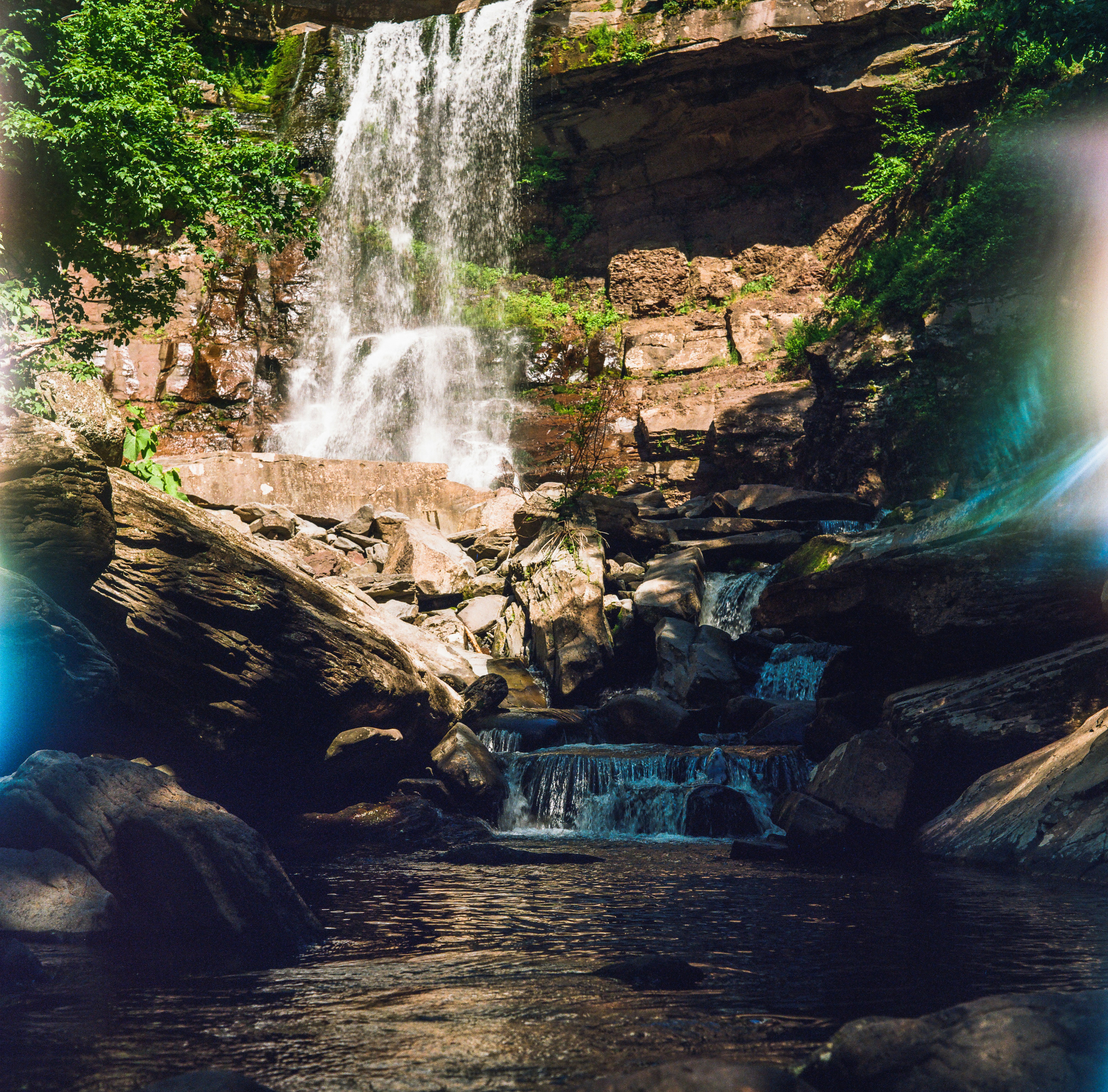 A waterfall is shown in the middle of a forest photo – Free Waterfall ...
