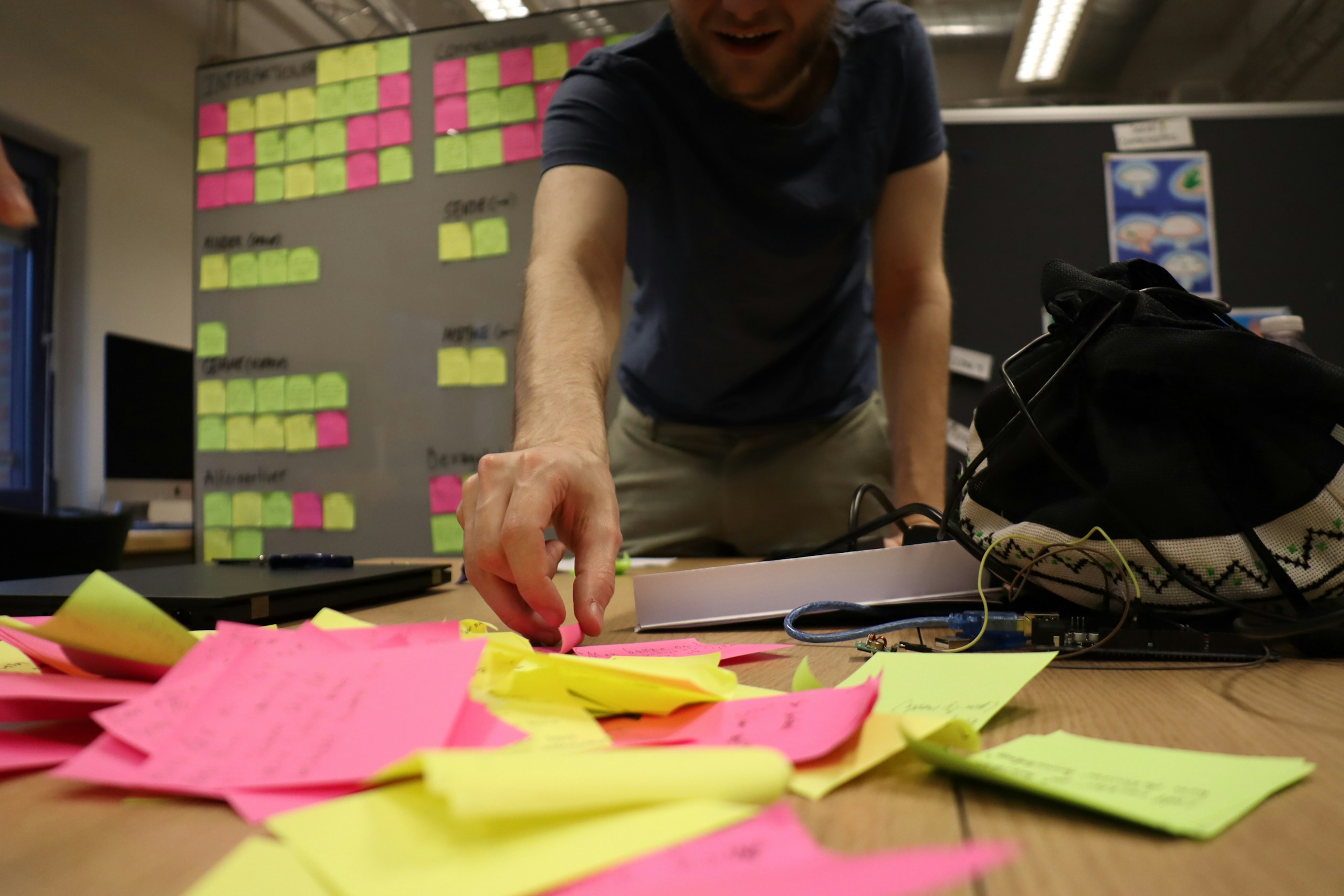 a man is working on a project with sticky notes