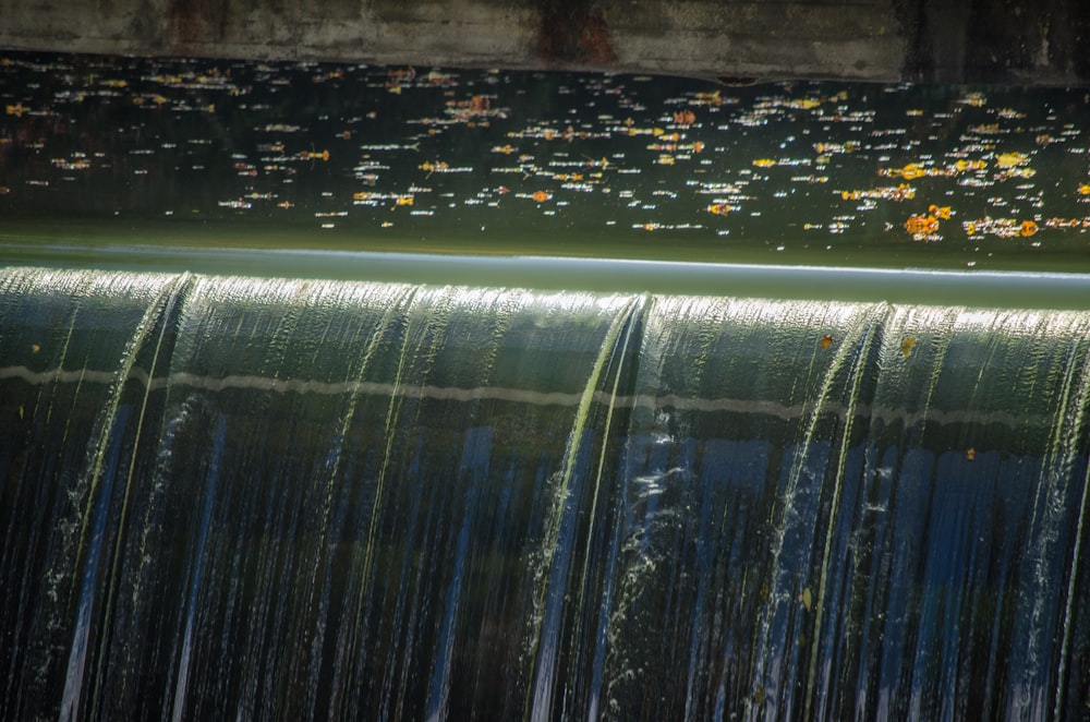 the water is running down the side of the waterfall