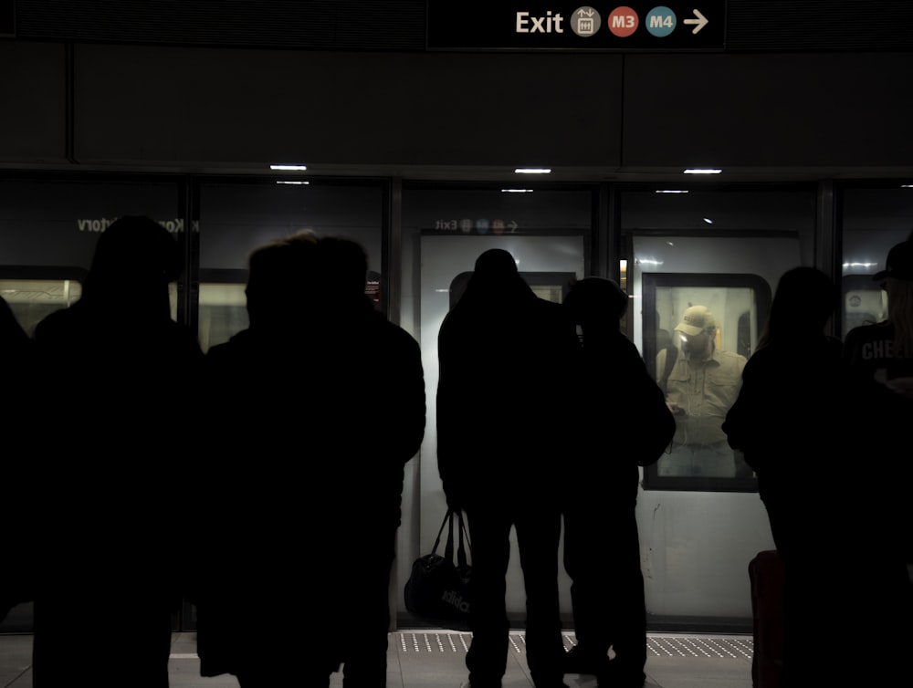 a group of people waiting at a train station