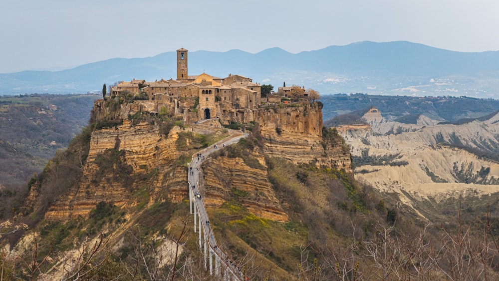 a castle on top of a mountain with a walkway leading to it