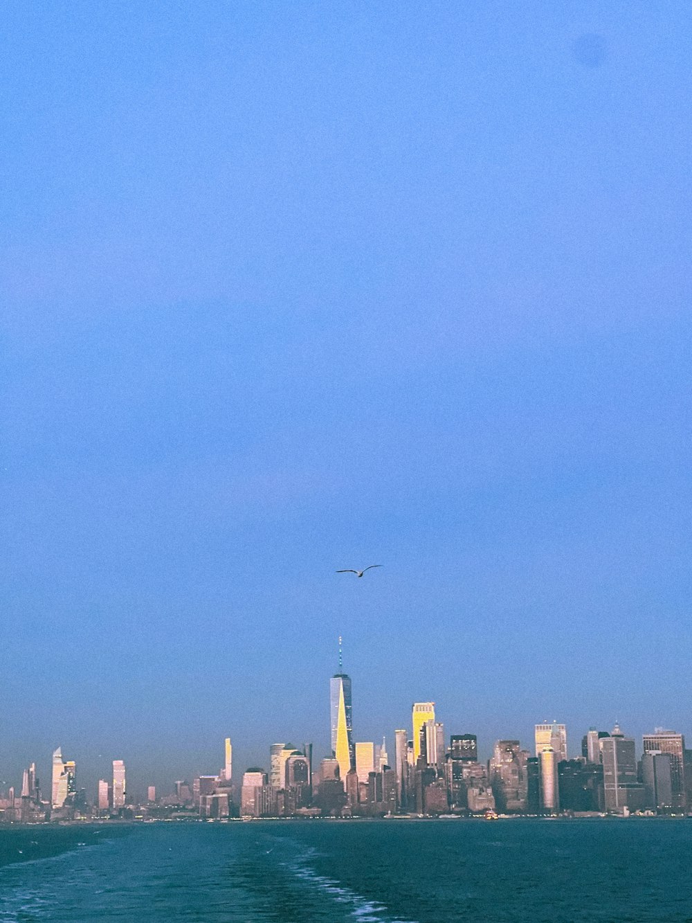 a large body of water with a city in the background