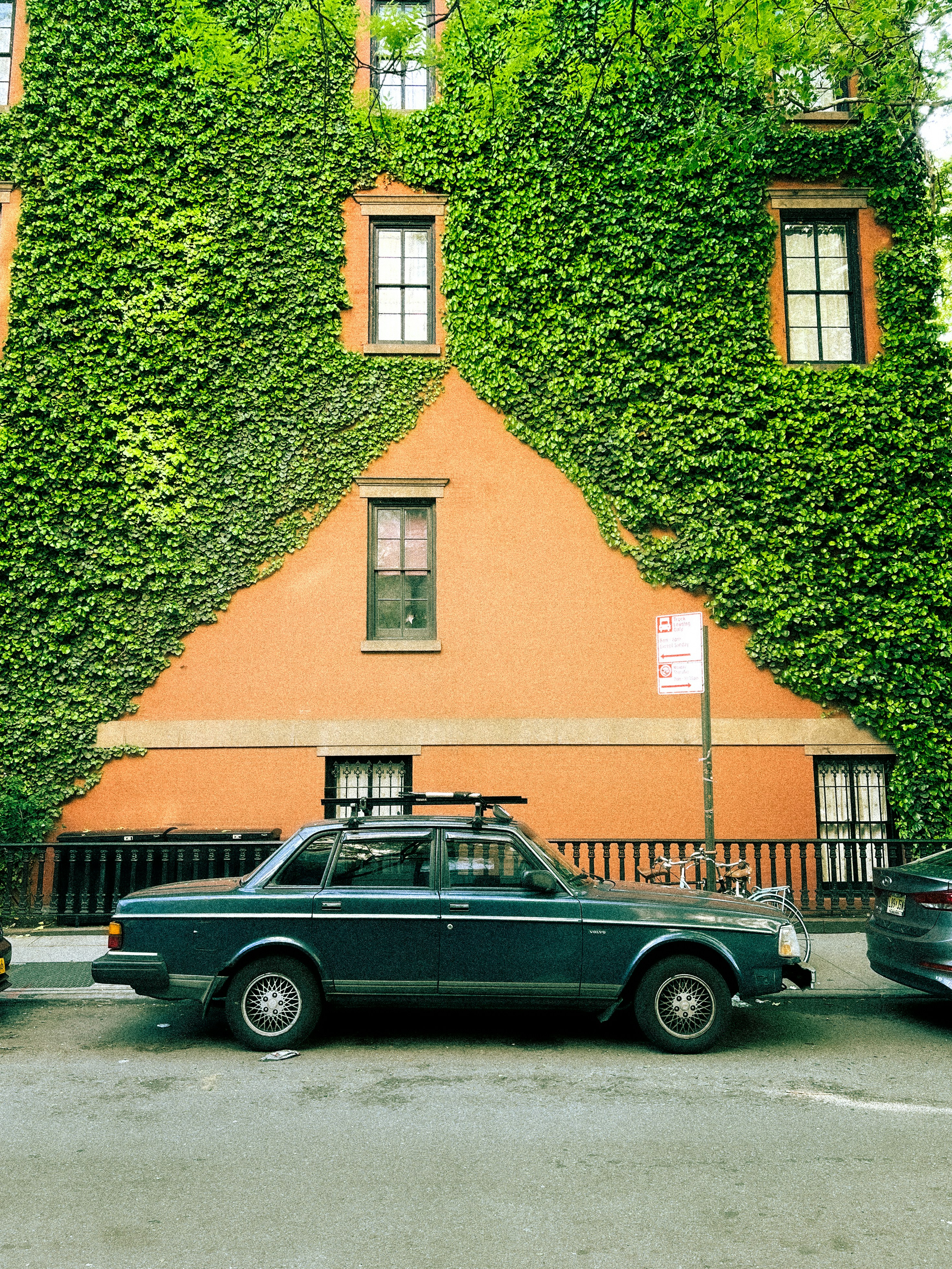 A car parked in front of a building covered in vines photo – Free West ...