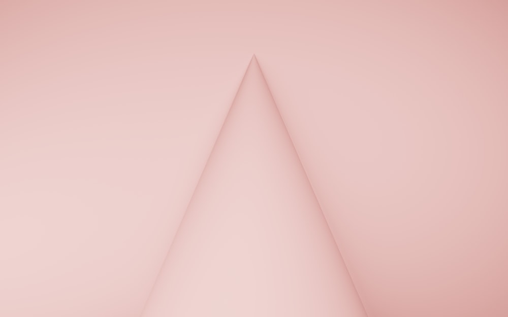 a white triangle on a pink background