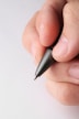 a person holding a pen in their left hand