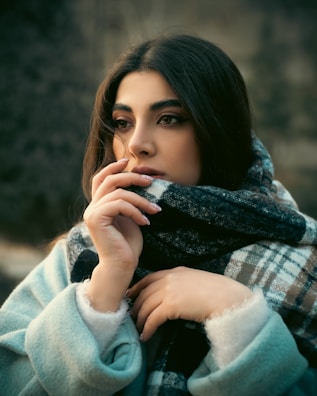 Cozy winter look with a chunky knit sweater and plaid scarf.