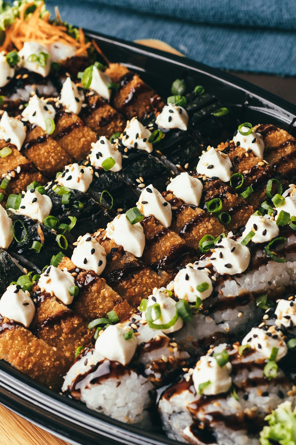 a platter of sushi and vegetables on a table