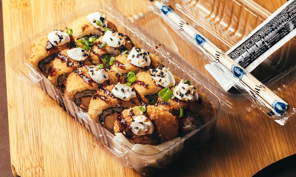 a plastic container filled with food on top of a wooden table