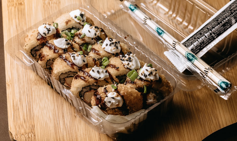 a container of food sitting on top of a wooden table