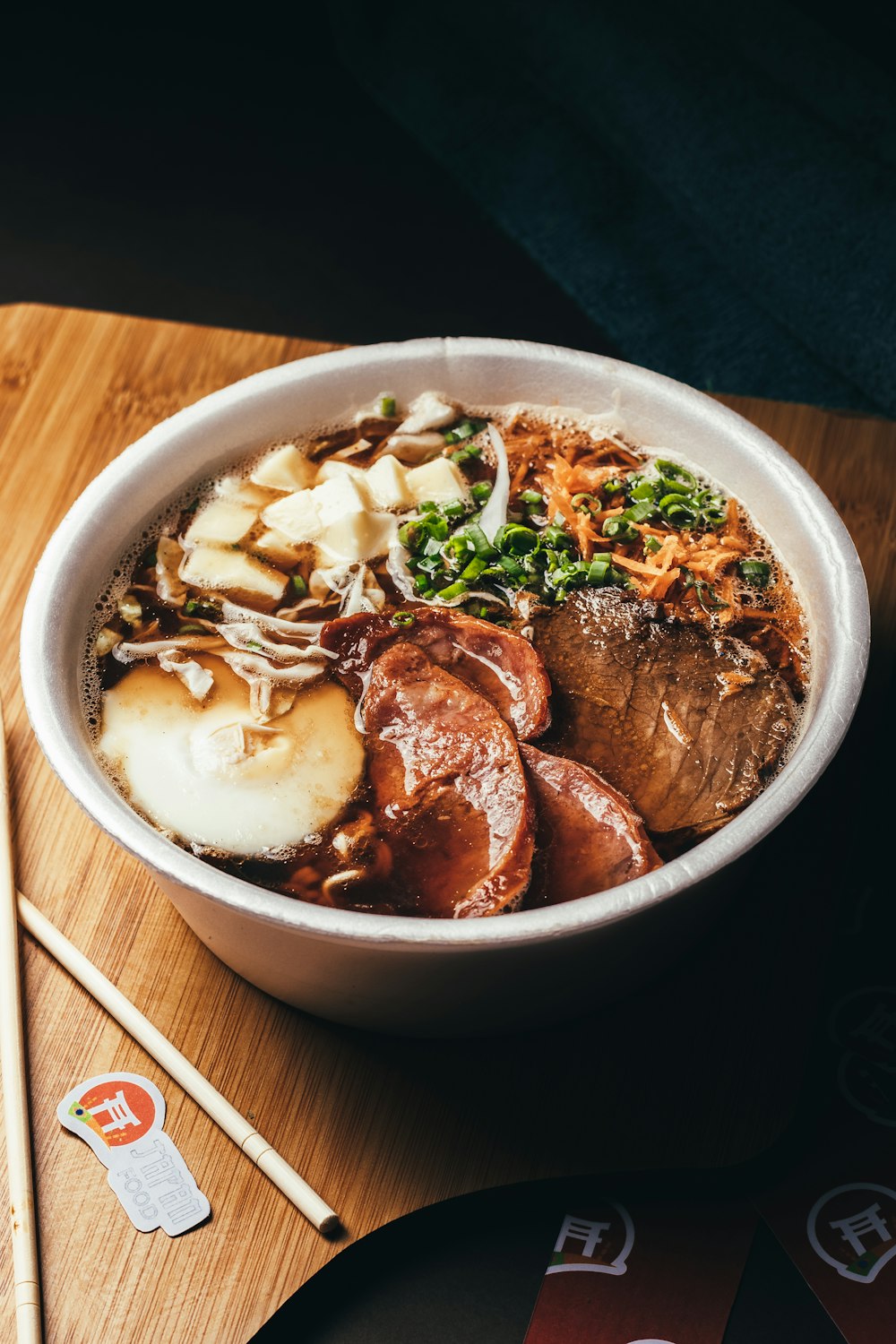 a bowl of food with chopsticks next to it