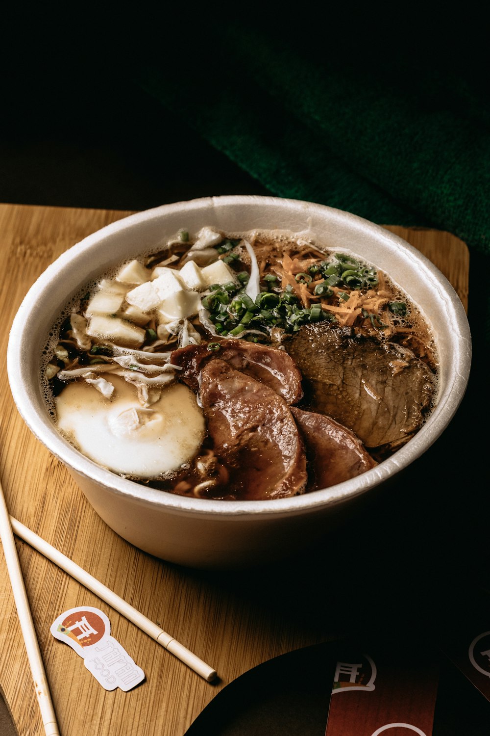 a bowl of food is sitting on a cutting board