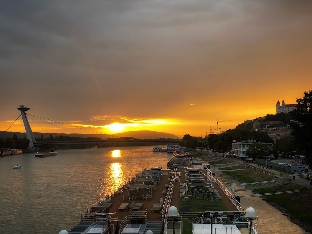 the sun is setting over a large body of water