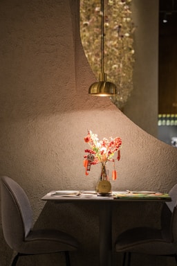 Cozy restaurant table set for an event with elegant menus and soft lighting.