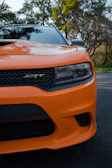 a close up of the front of an orange sports car