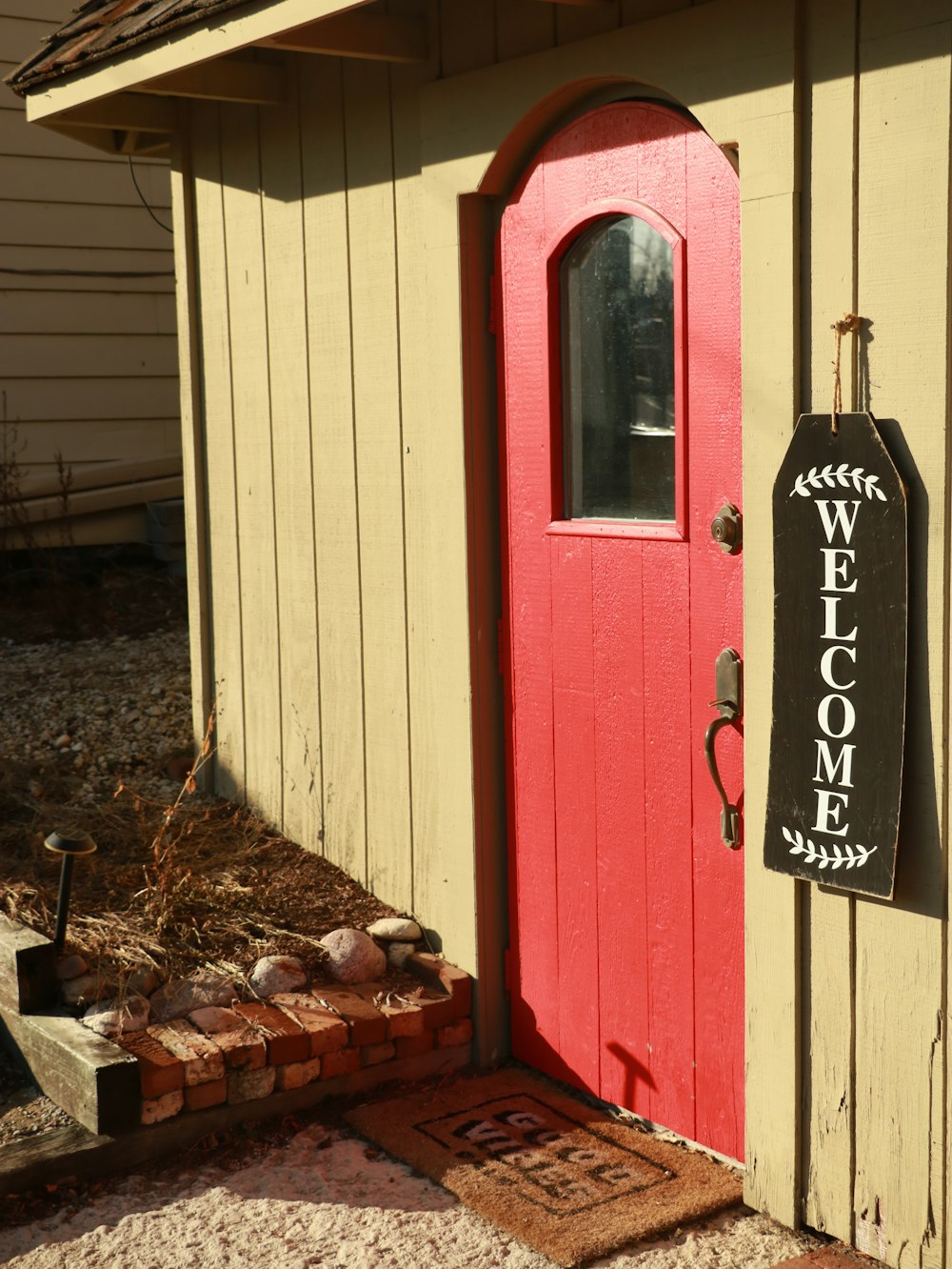 a red door with a welcome sign on it