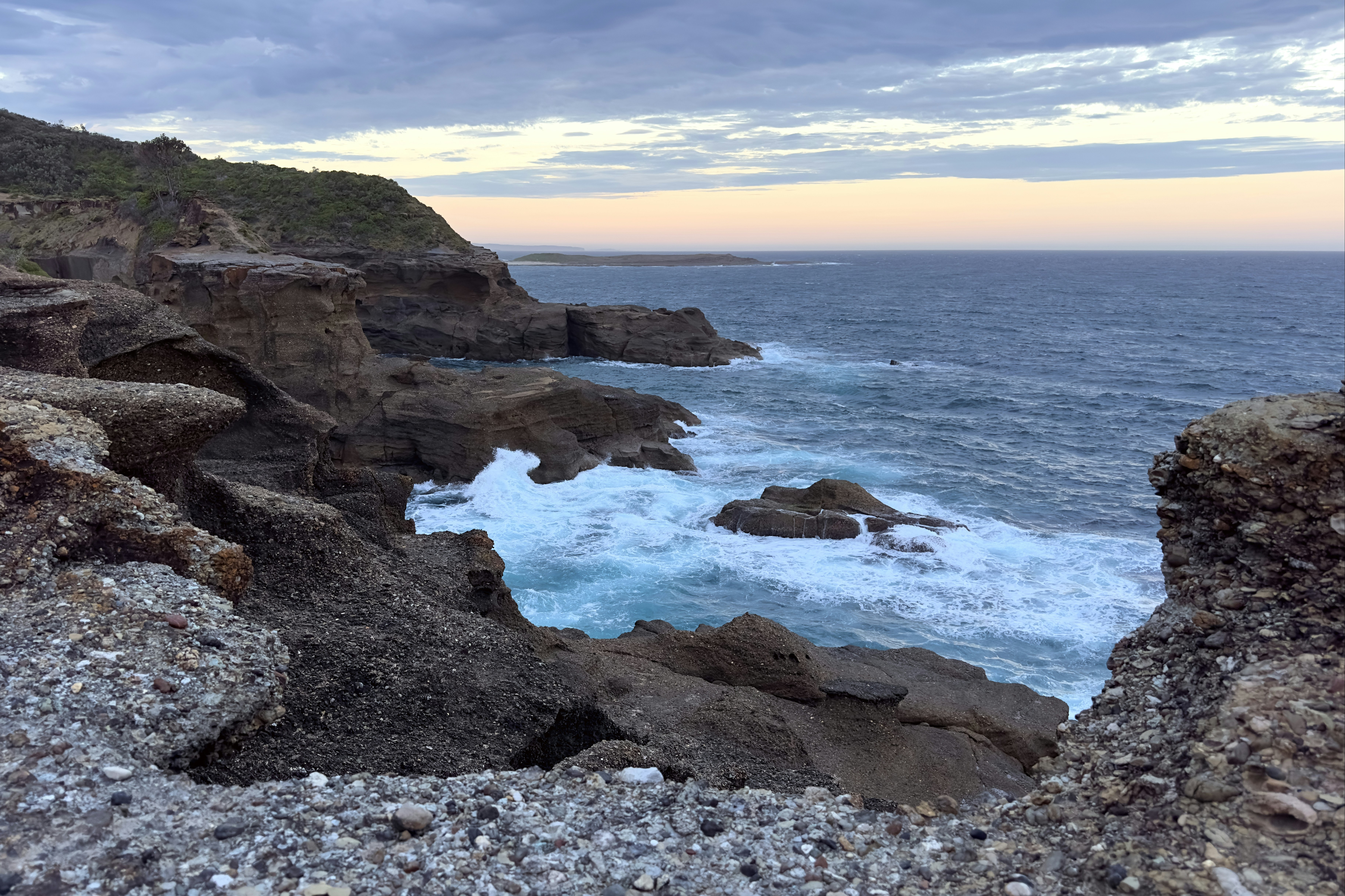 a view of the ocean from a rocky cliff