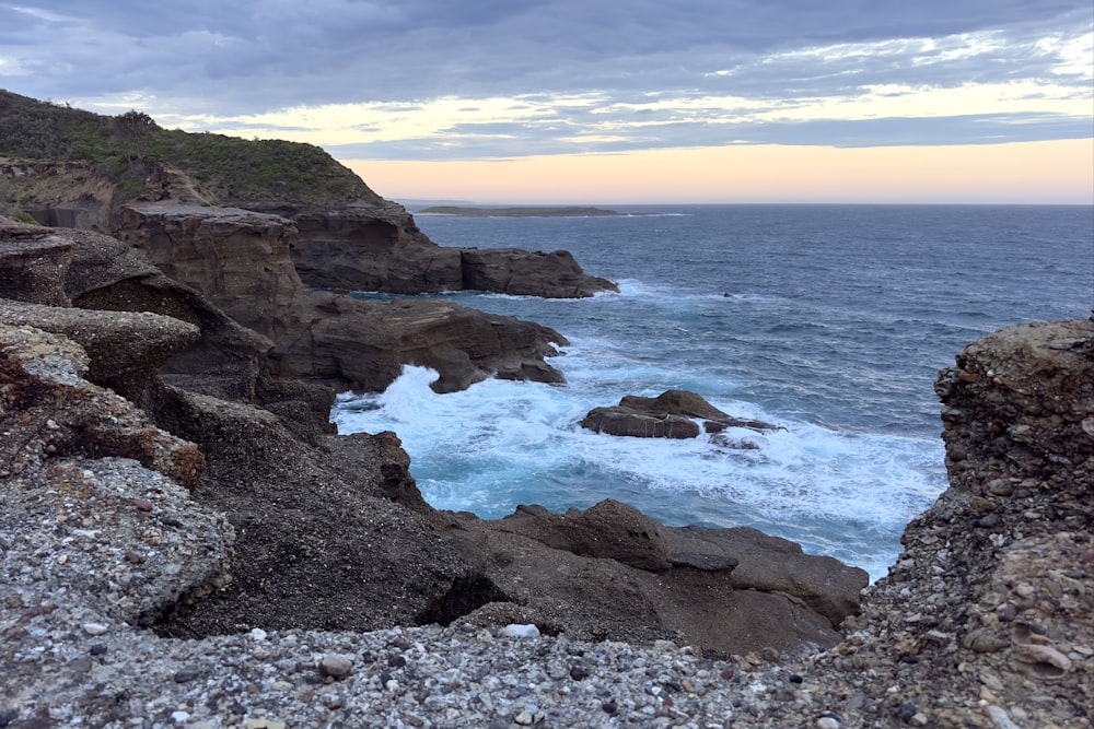 a view of the ocean from a rocky cliff