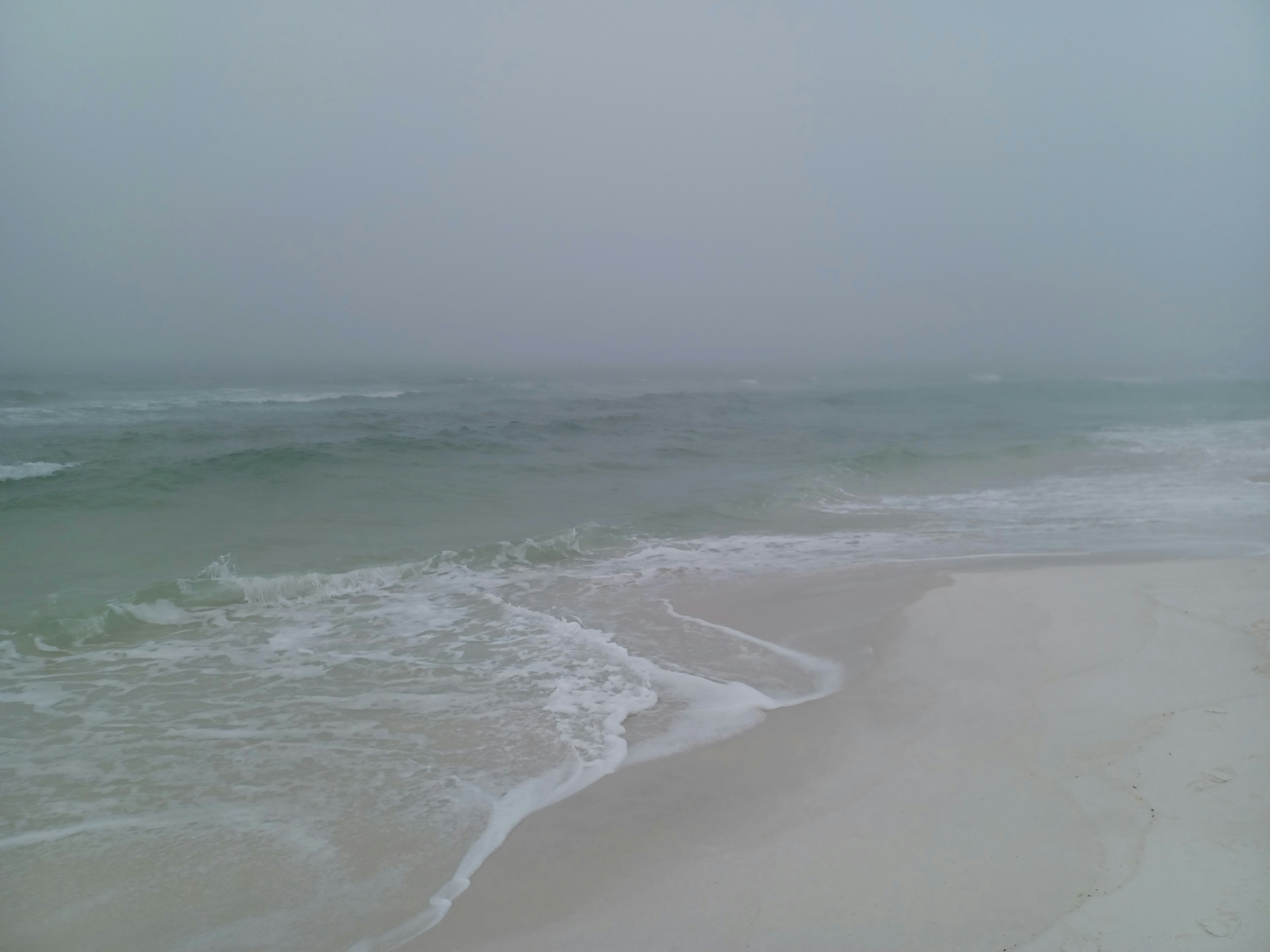 a beach with waves coming in to shore