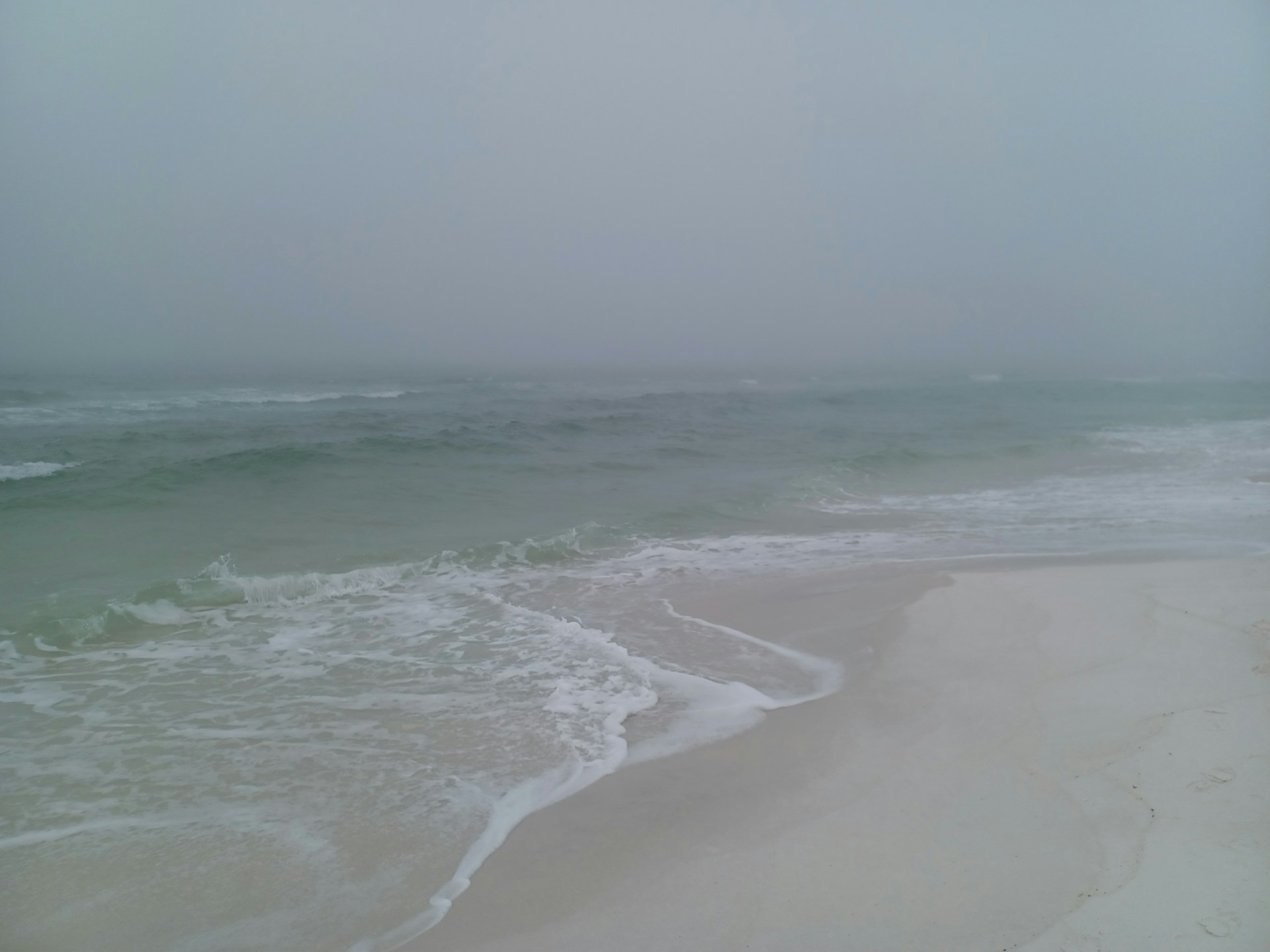 a beach with waves coming in to shore