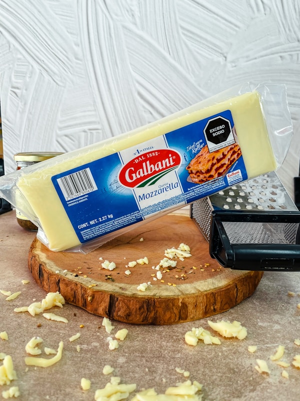 A piece of cheese sitting on top of a piece of bread