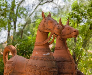 a statue of two horses made of clay