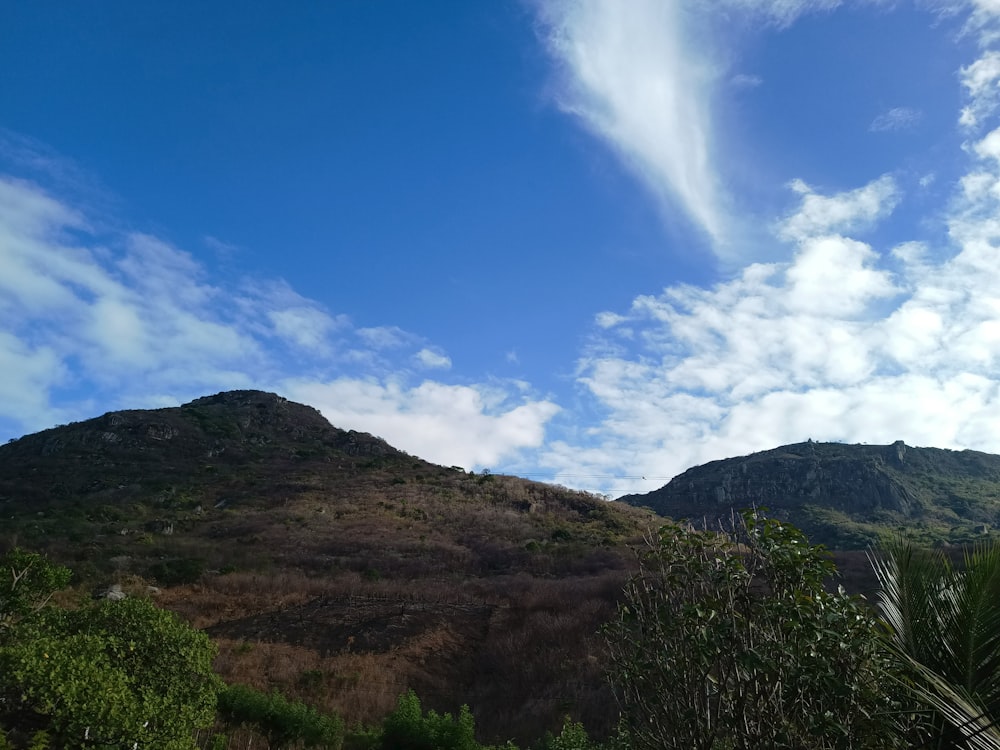 a view of a mountain with a cloud in the sky