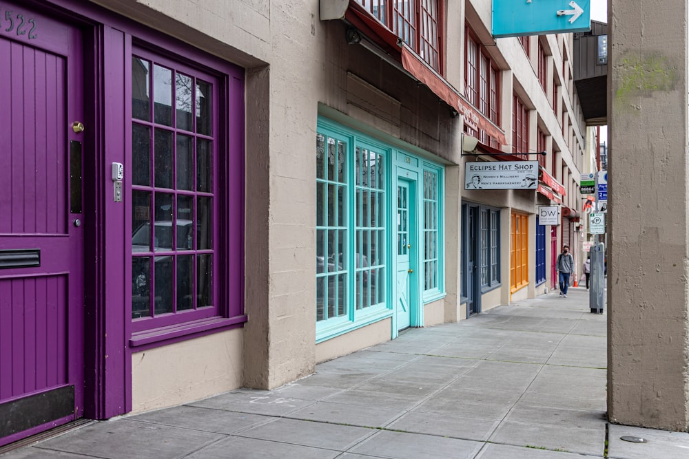 a row of colorful doors on the side of a building