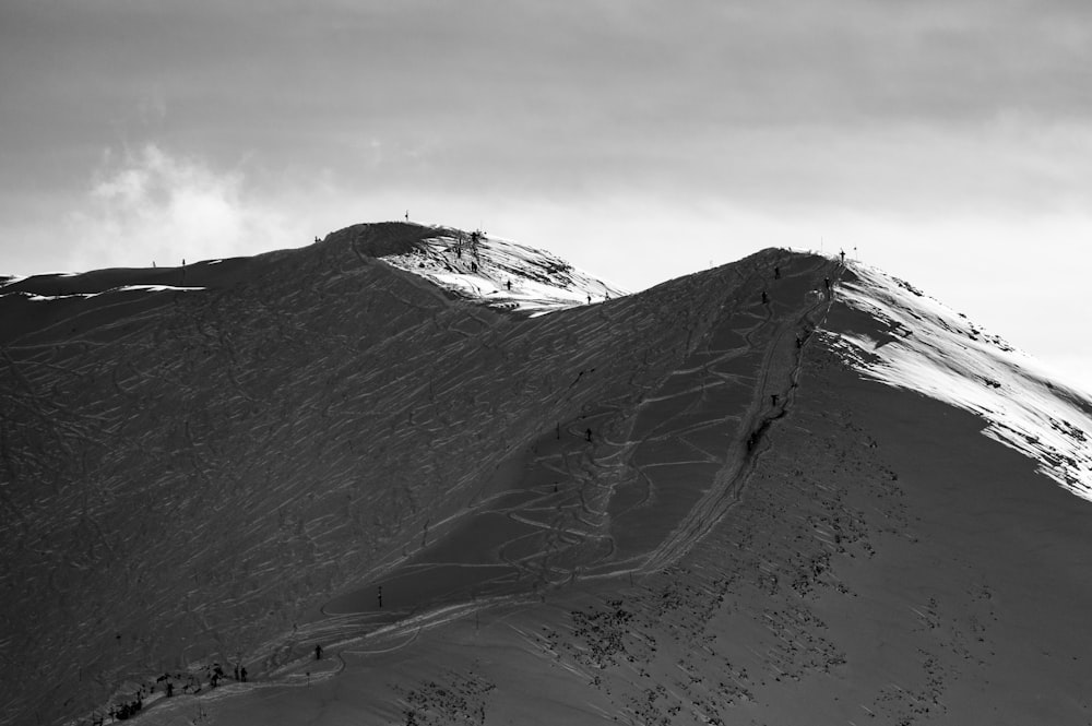 a black and white photo of a snow covered mountain