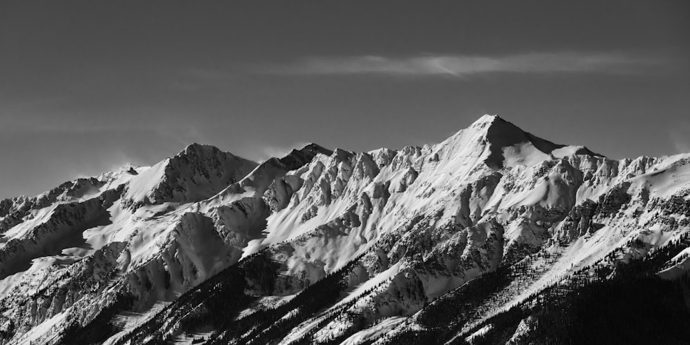 a black and white photo of a snow covered mountain