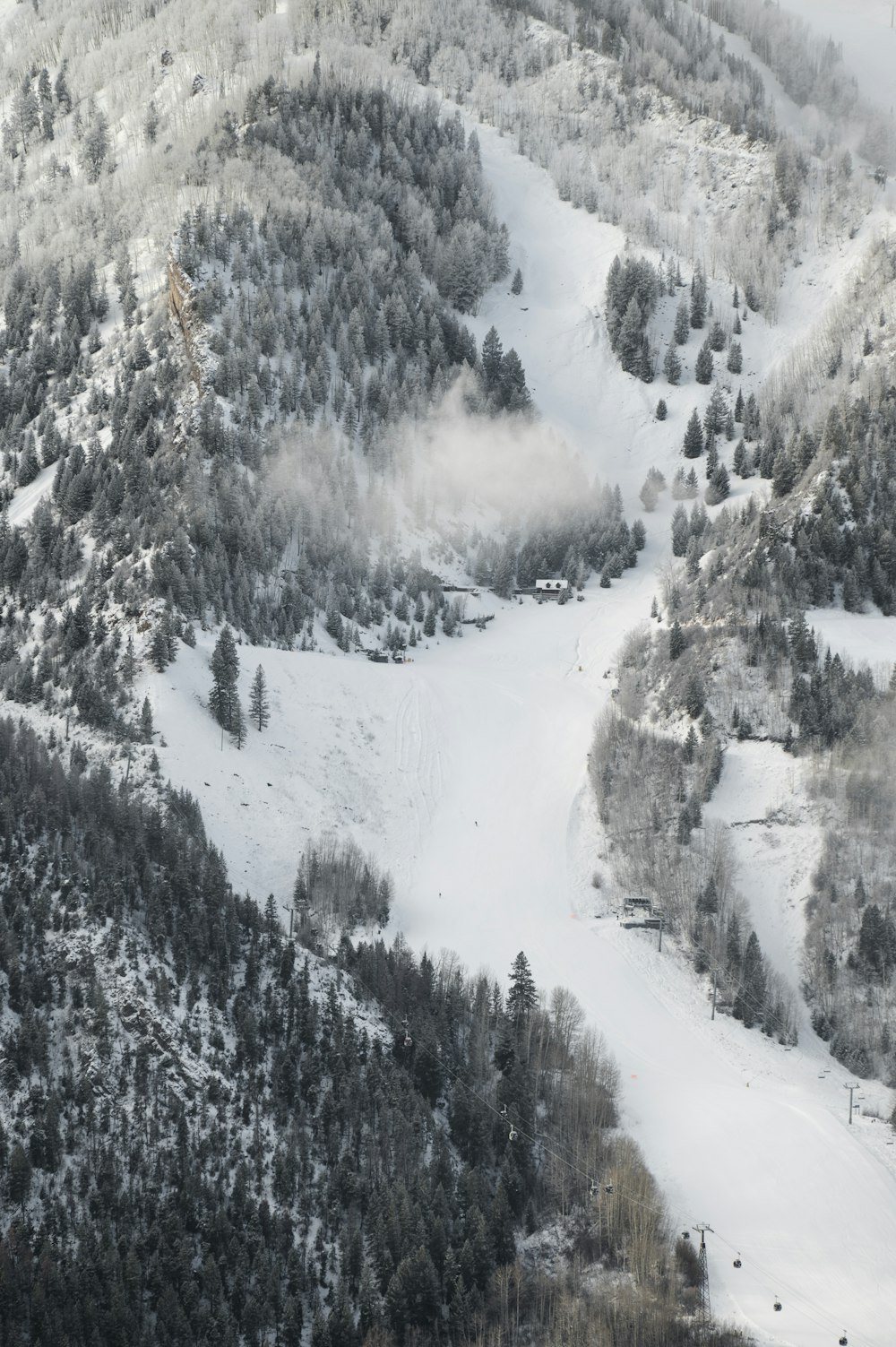 a snow covered mountain with a river running through it