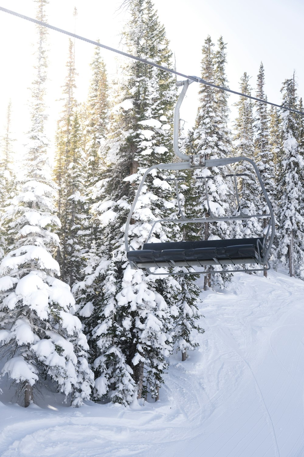 a person riding a ski lift in the snow