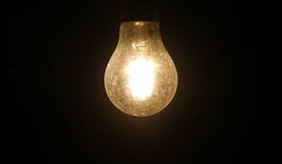 A light bulb glowing brightly symbolizing ideas and discoveries.