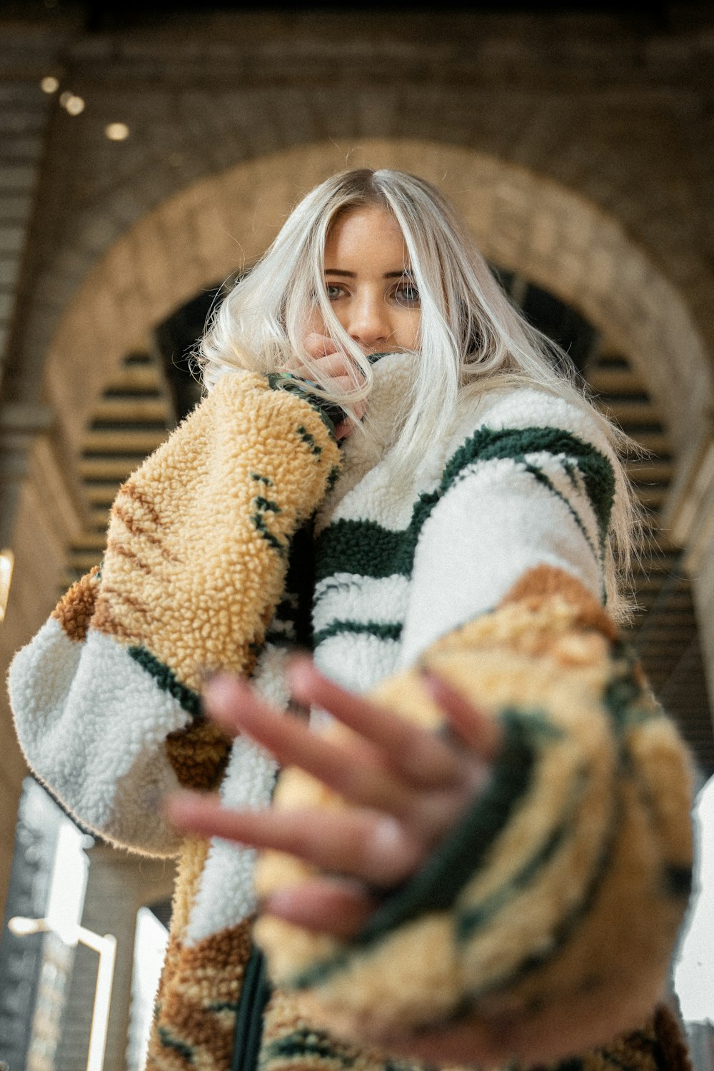 a woman with white hair is holding a stuffed animal